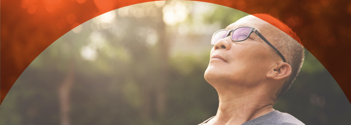 Happy senior male wear glasses relaxing and breathing fresh air at park
