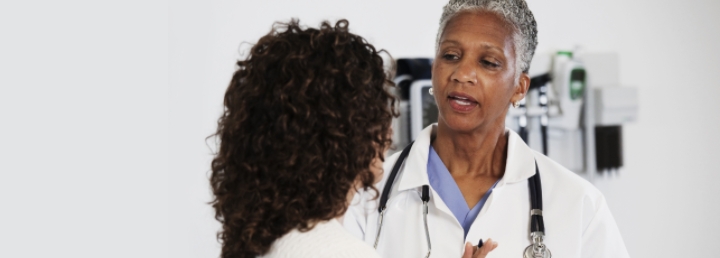 Image of doctor consulting patient in their office.